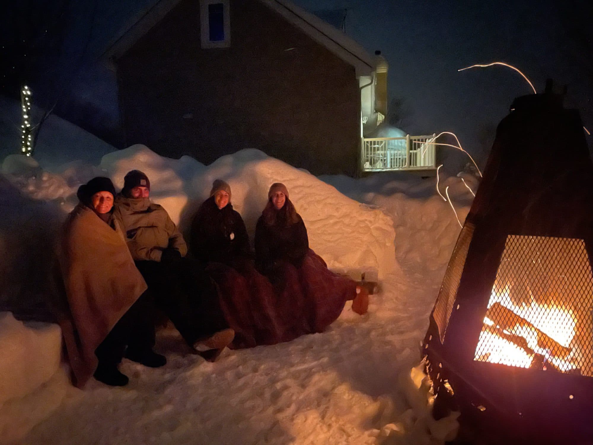 Your hosts at the firepit by the water